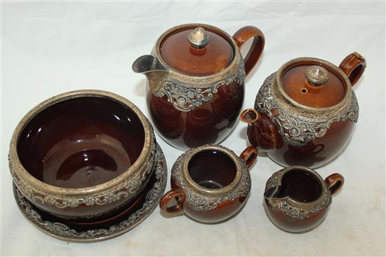 Wedgwood treacle glazed pottery silver mounted part tea set, c.1906, the hot water pot 13cm., one plate broken (13)(-)